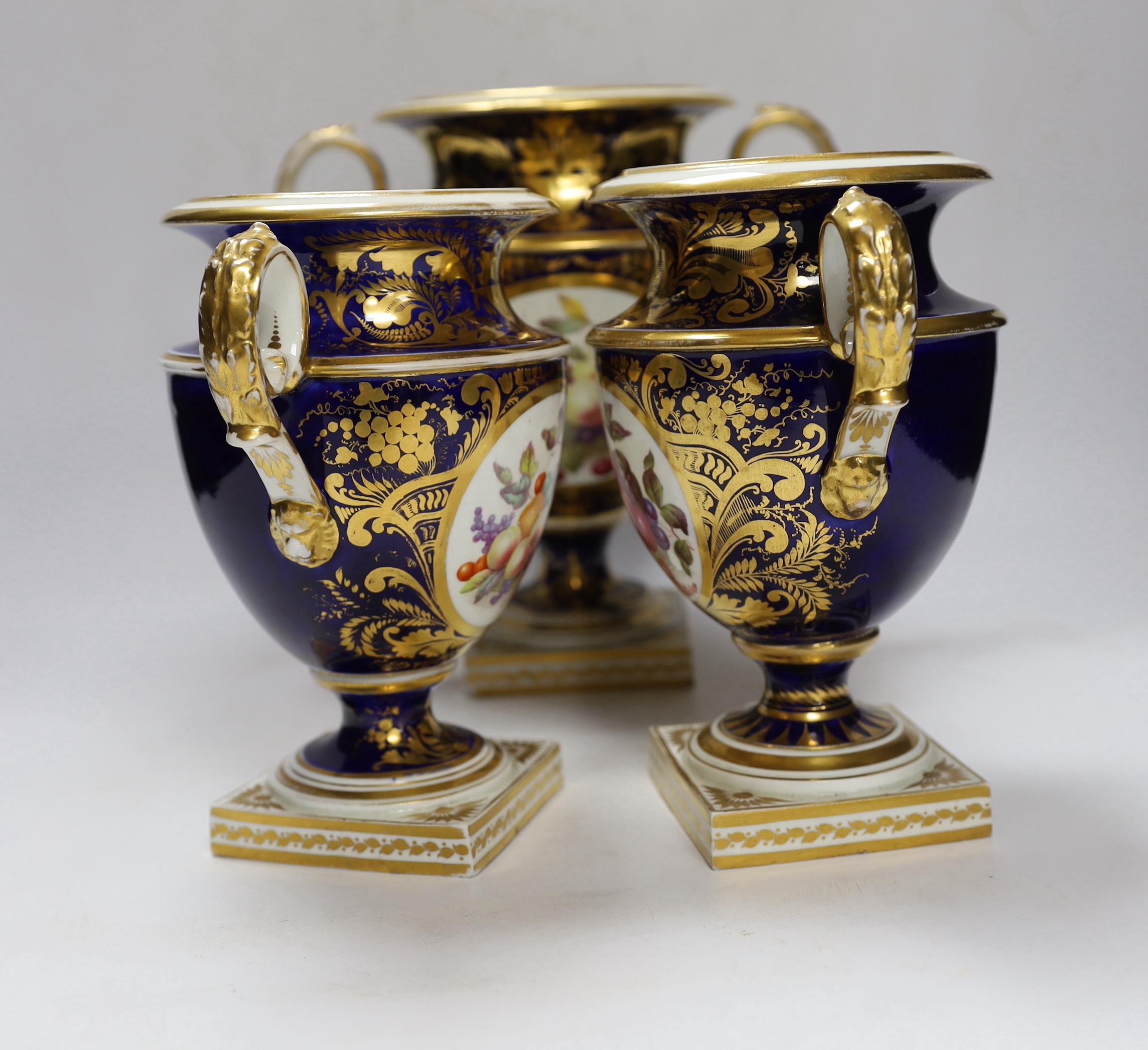 A garniture of three early 19th century Derby vases painted with fruit, tallest 23cm